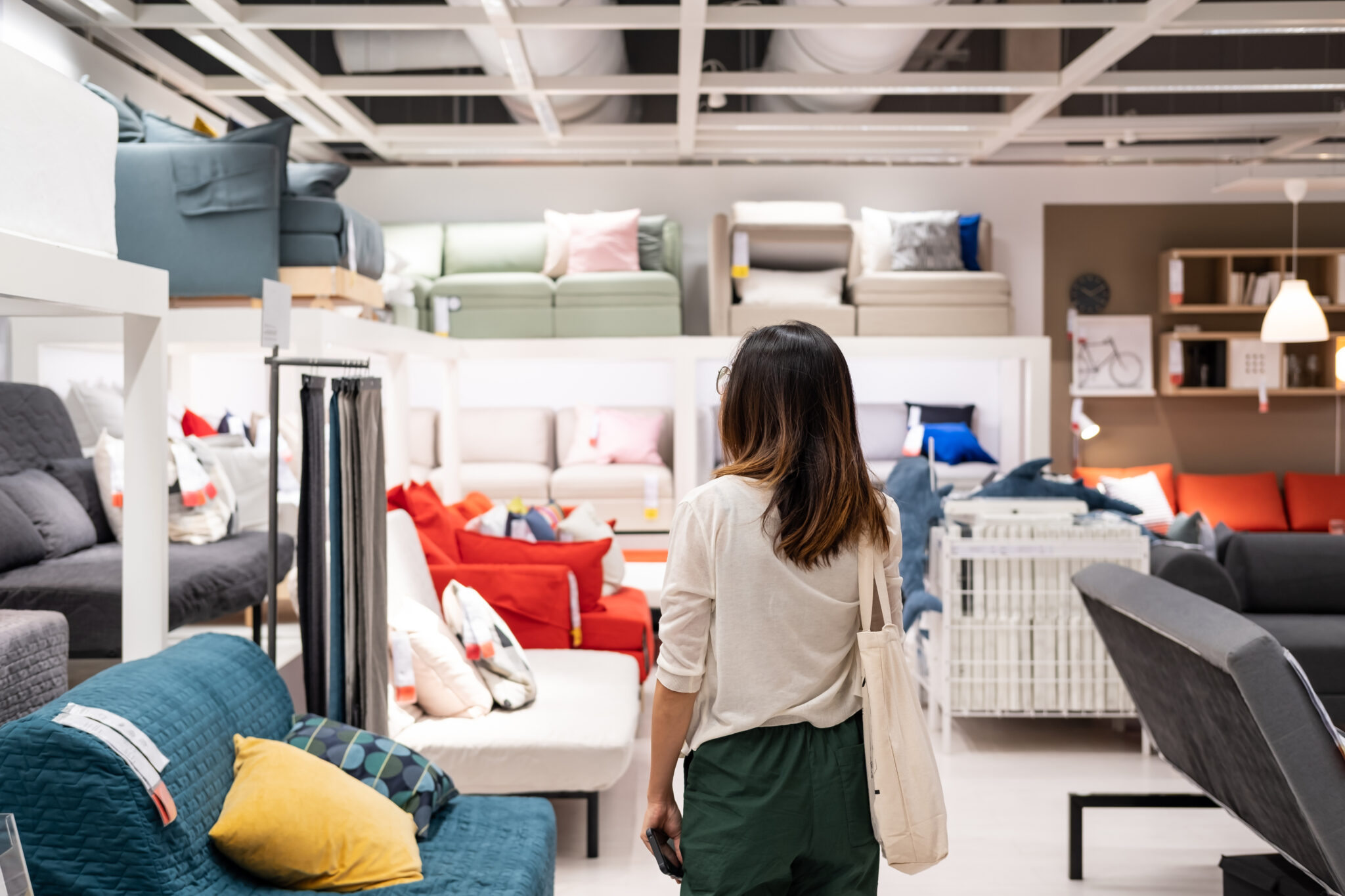 Woman standing in home furnishing shop floor